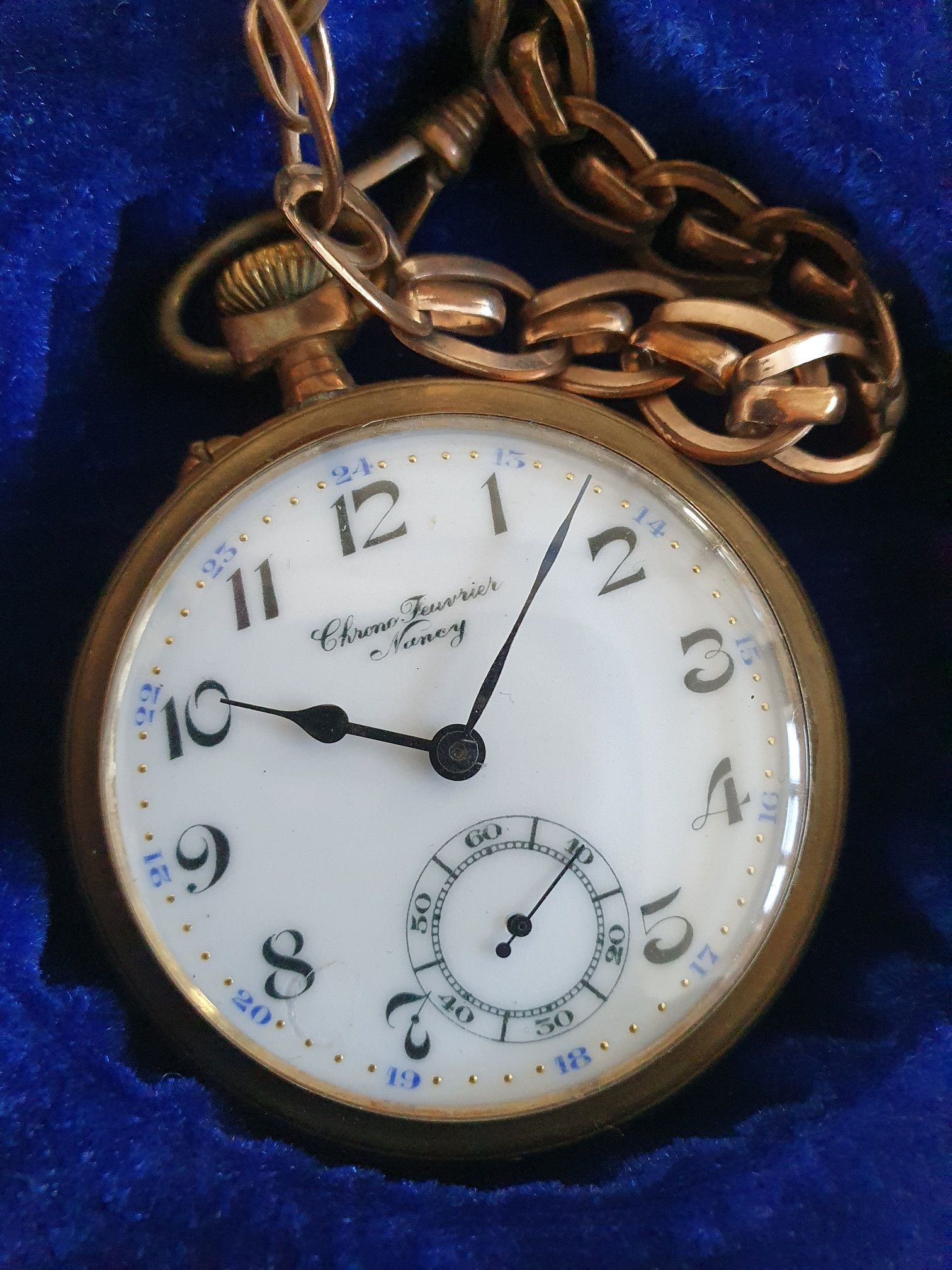 Gold pocket watch with chain.